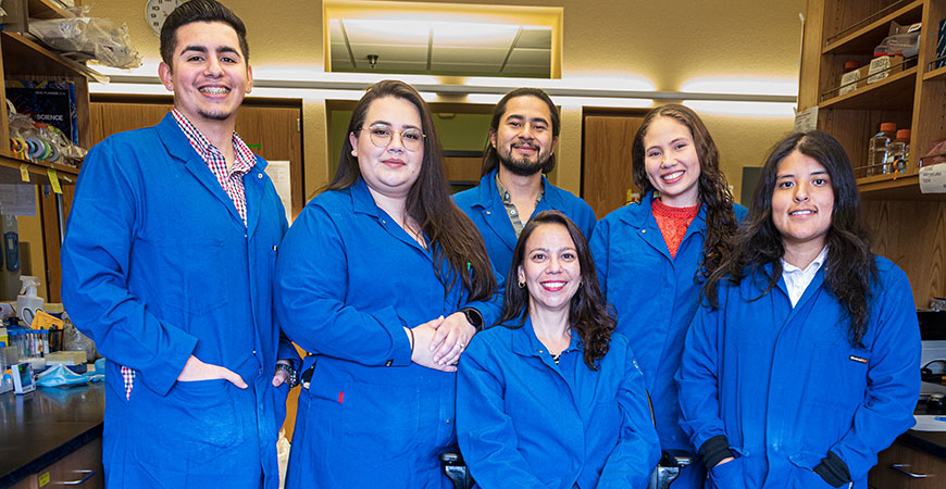 Professor Zoghbi, seated, and some of the students in her lab.